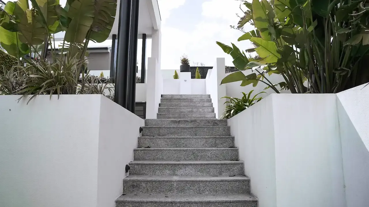 Stairs leading up to the pool house.