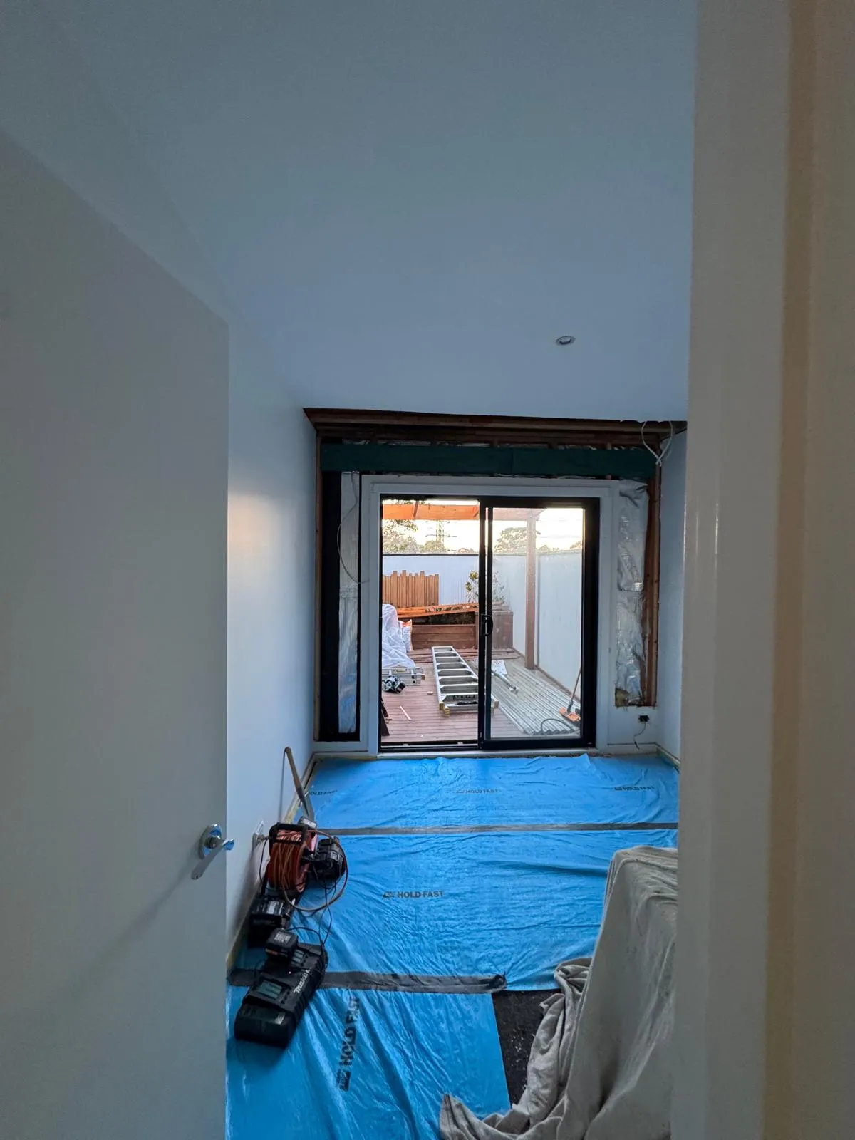 New doors framed into an opened wall, floors protected