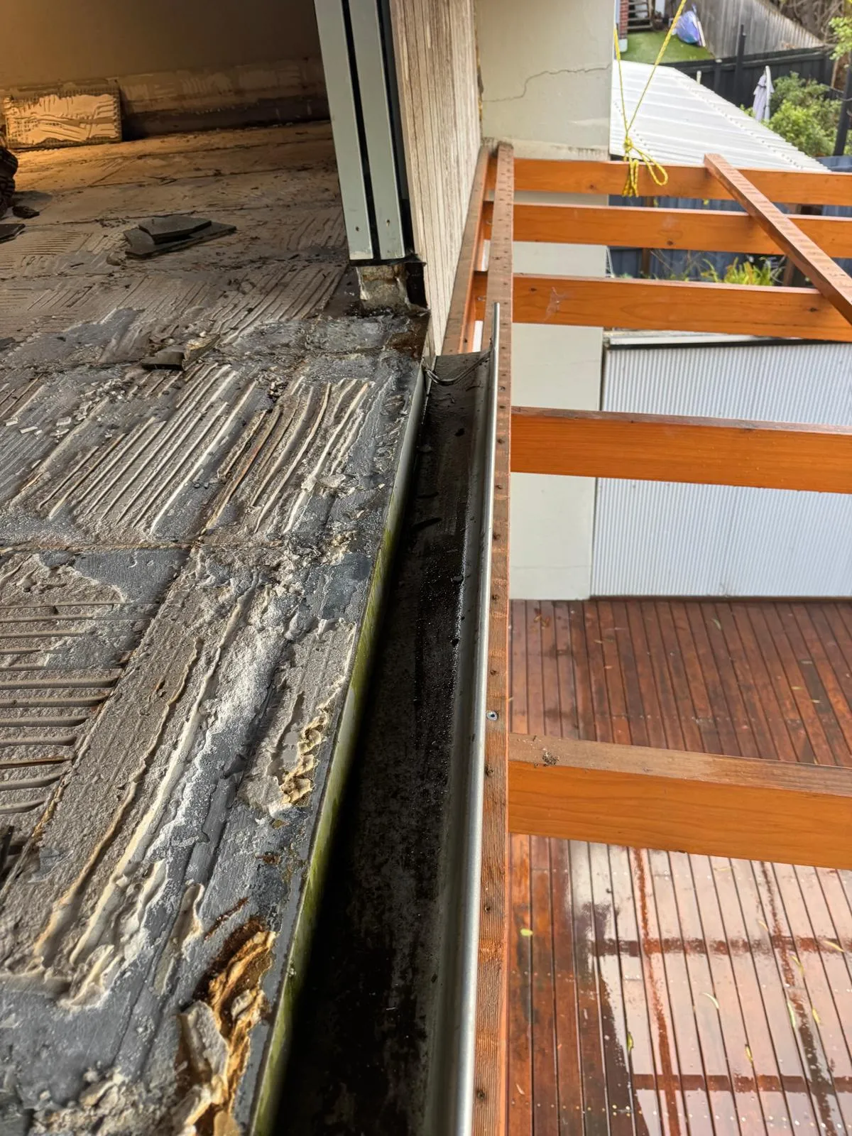 Balcony threshold with waterproofing membrane and tile bed exposed