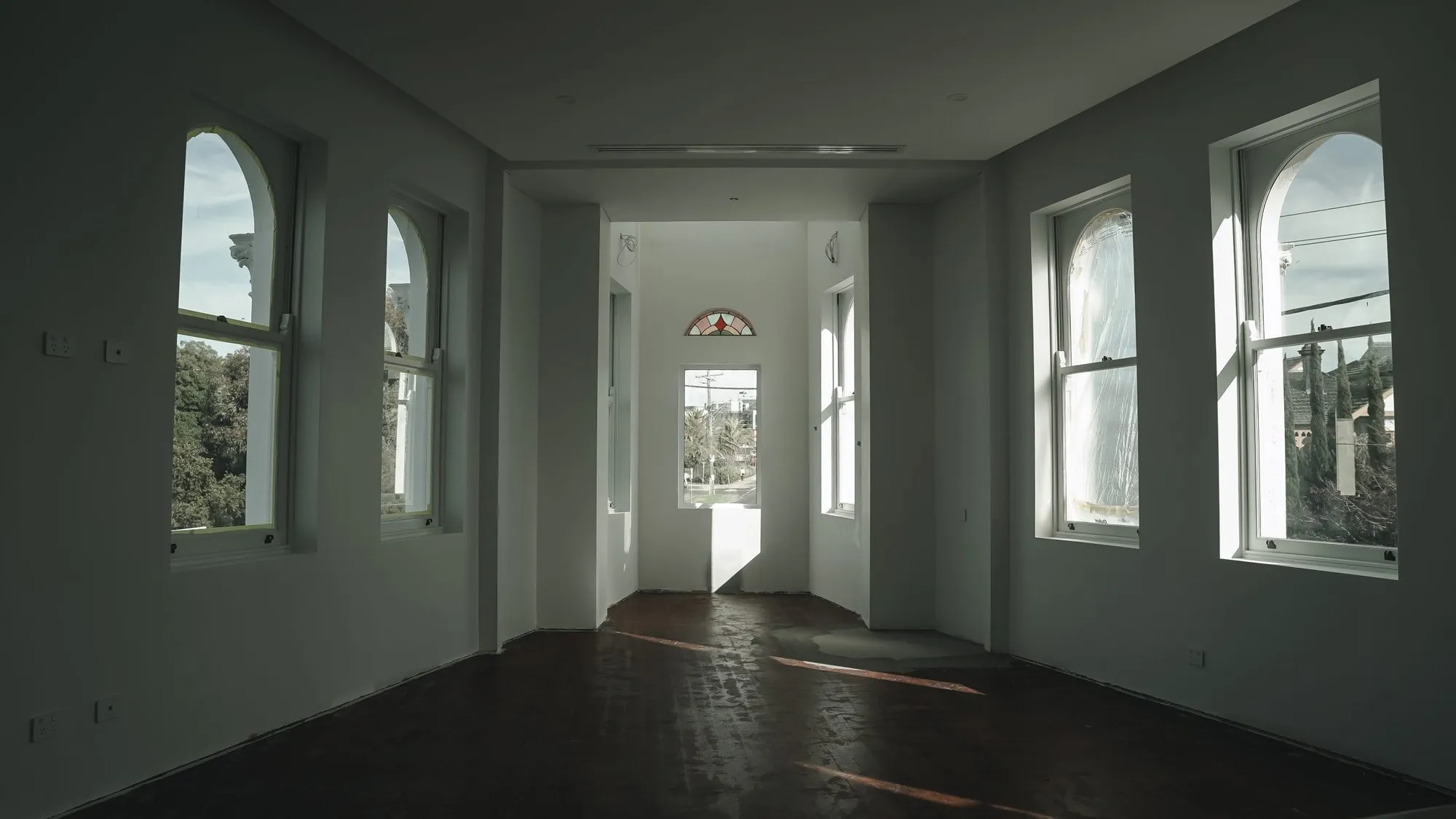 Heritage hallway with arched windows during restoration