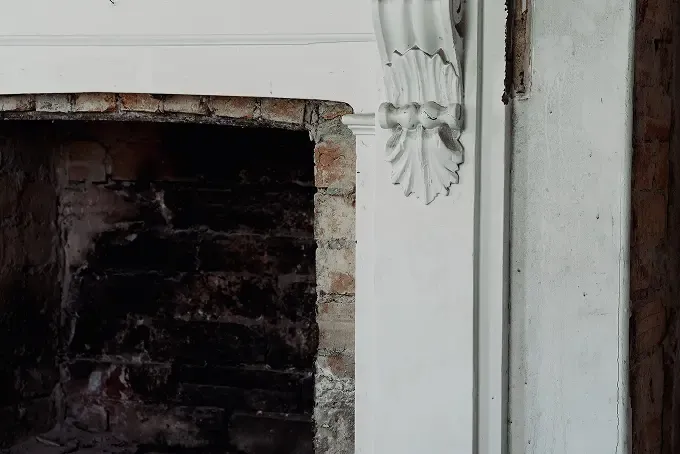 Top right corner of an aging fireplace from a heritage home.