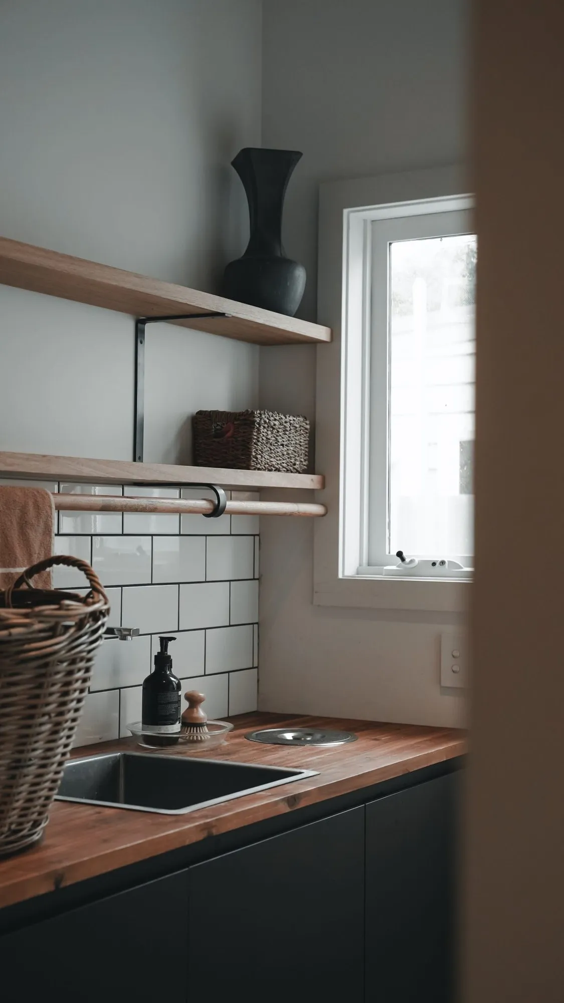 Dark timber kitchen joinery in a completed renovation